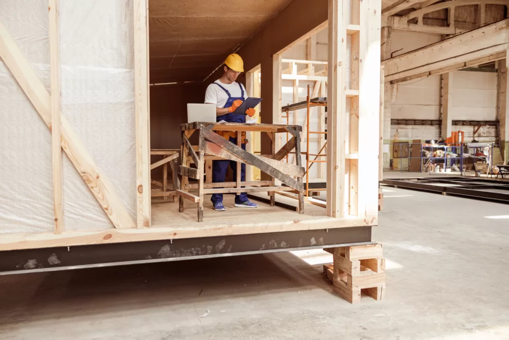 male-builder-writing-on-clipboard-at-construction-2023-11-27-05-25-13-utc-1024x683-1